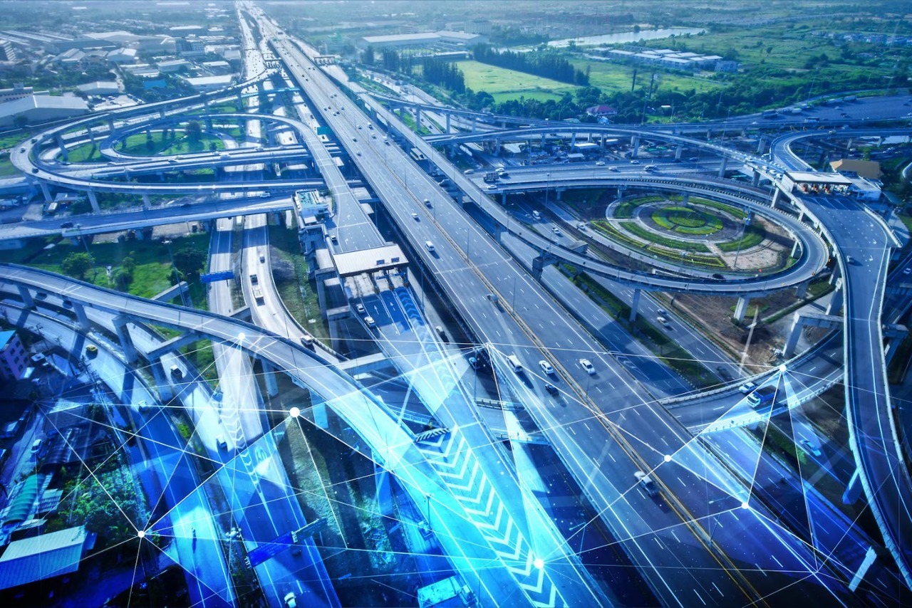 Aerial view of a complex highway interchange, showcasing multiple roads and traffic flow, highlighting urban infrastructure and connectivity.