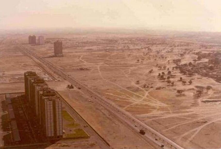 Desert landscape with urban structures in the foreground, illustrating the contrast between development and arid terrain, relevant for discussions on urbanization.
